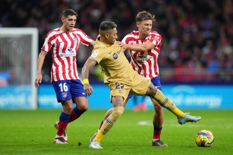 MADRID, SPAIN - JANUARY 08: Raphinha of FC Barcelona battles for possession with Marcos Llorente of Atletico Madridduring the LaLiga Santander match between Atletico de Madrid and FC Barcelona at Civitas Metropolitano Stadium on January 08, 2023 in Madrid, Spain. (Photo by Angel Martinez/Getty Images)