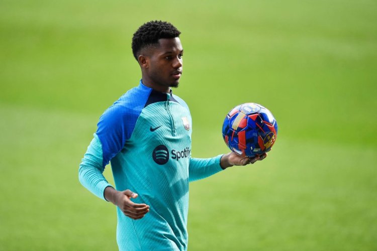 Barcelona's Spanish midfielder Ansu Fati holds a ball during a training session, open to fans, at the Camp Nou stadium in Barcelona on January 2, 2023. (Photo by Pau BARRENA / AFP) (Photo by PAU BARRENA/AFP via Getty Images)