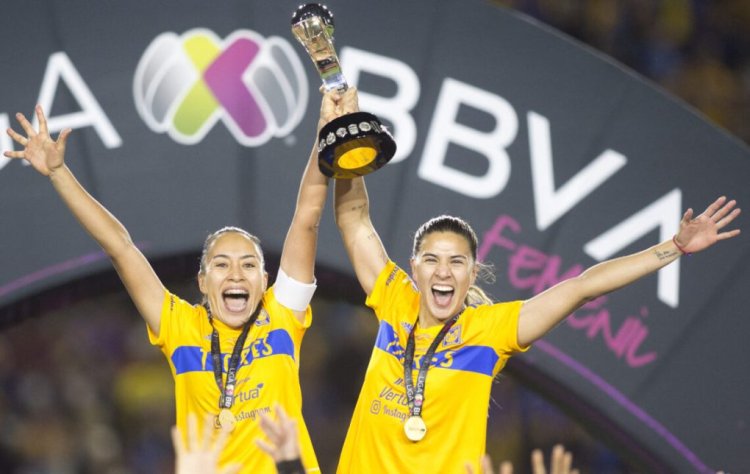 Tigres Femenil team players hold the trophy and celebrate after winning the Liga MX Femenil Apertura 2022 football tournament by defeating America at the Universitario stadium in Monterrey, Mexico, on November 14, 2022. (Photo by Julio Cesar AGUILAR / AFP) (Photo by JULIO CESAR AGUILAR/AFP via Getty Images)