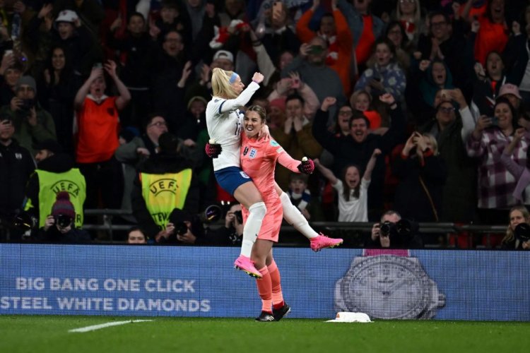 England's striker Chloe Kelly celebrates England's goalkeeper Mary Earps after scoring the final and winning penalty kick during the "Finalissima" International football match between England and Brazil at Wembley Stadium in London on April 6, 2023. - England's wins against Brazil. (Photo by Ben Stansall / AFP) (Photo by BEN STANSALL/AFP via Getty Images)